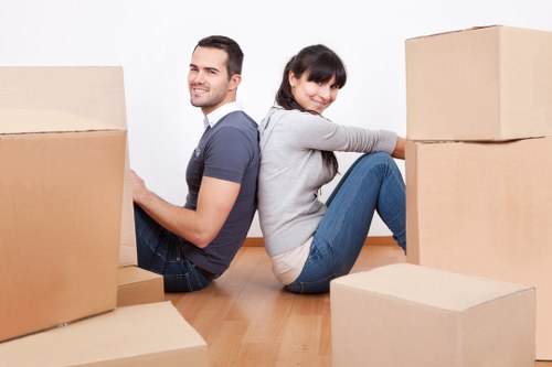 Moving boxes and furniture being loaded into a van in West London