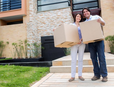 Professional movers carrying furniture in a flat conversion